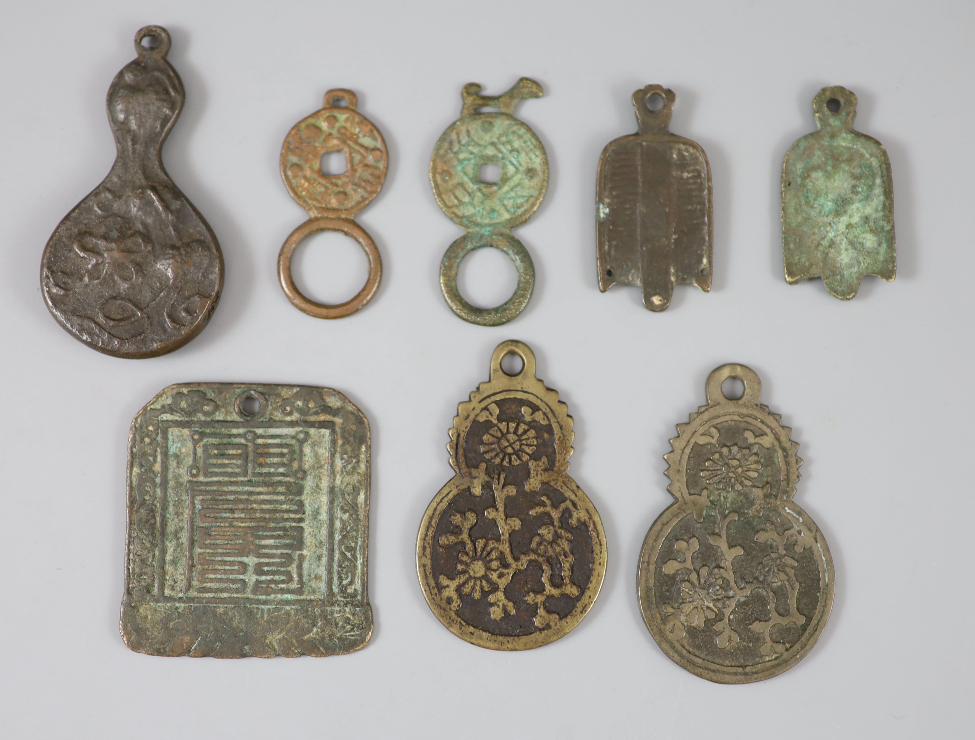 China, 8 bronze charms or amulets, Qing dynasty or earlier,